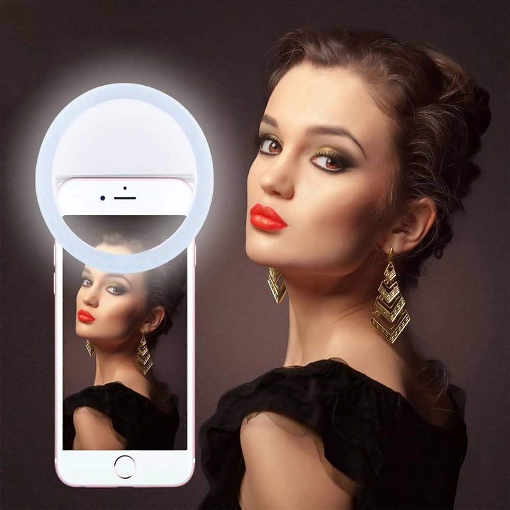 Woman with red lipstick and gold earrings using a smartphone with a ring light app.