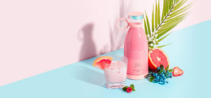 Pink water bottle and glass with pink drink on a pastel background